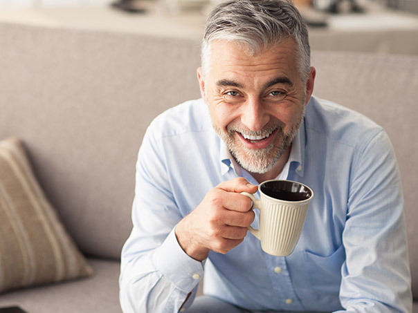 Male drinking coffee with Dental Implants