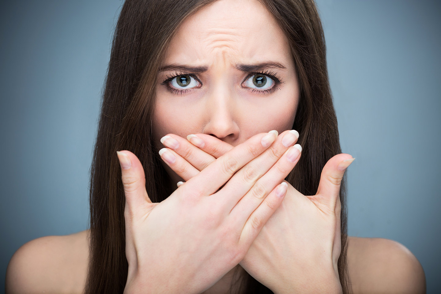 Lady covering her mouth because of bad breathe