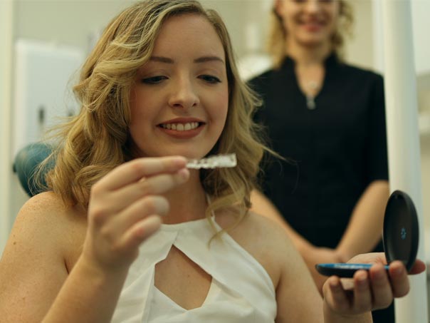 Lady looking at Invisalign for fitting in her mouth