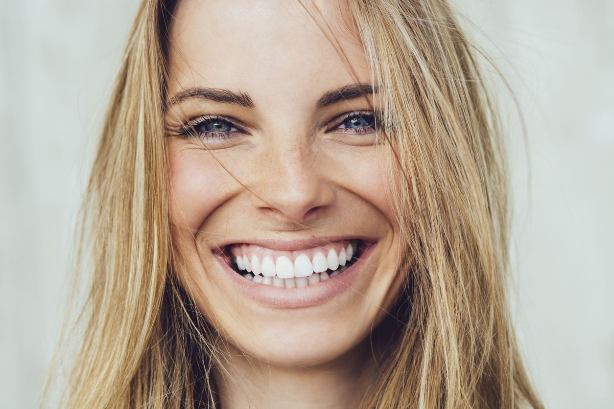 beautiful blonde smiling with straight white teeth