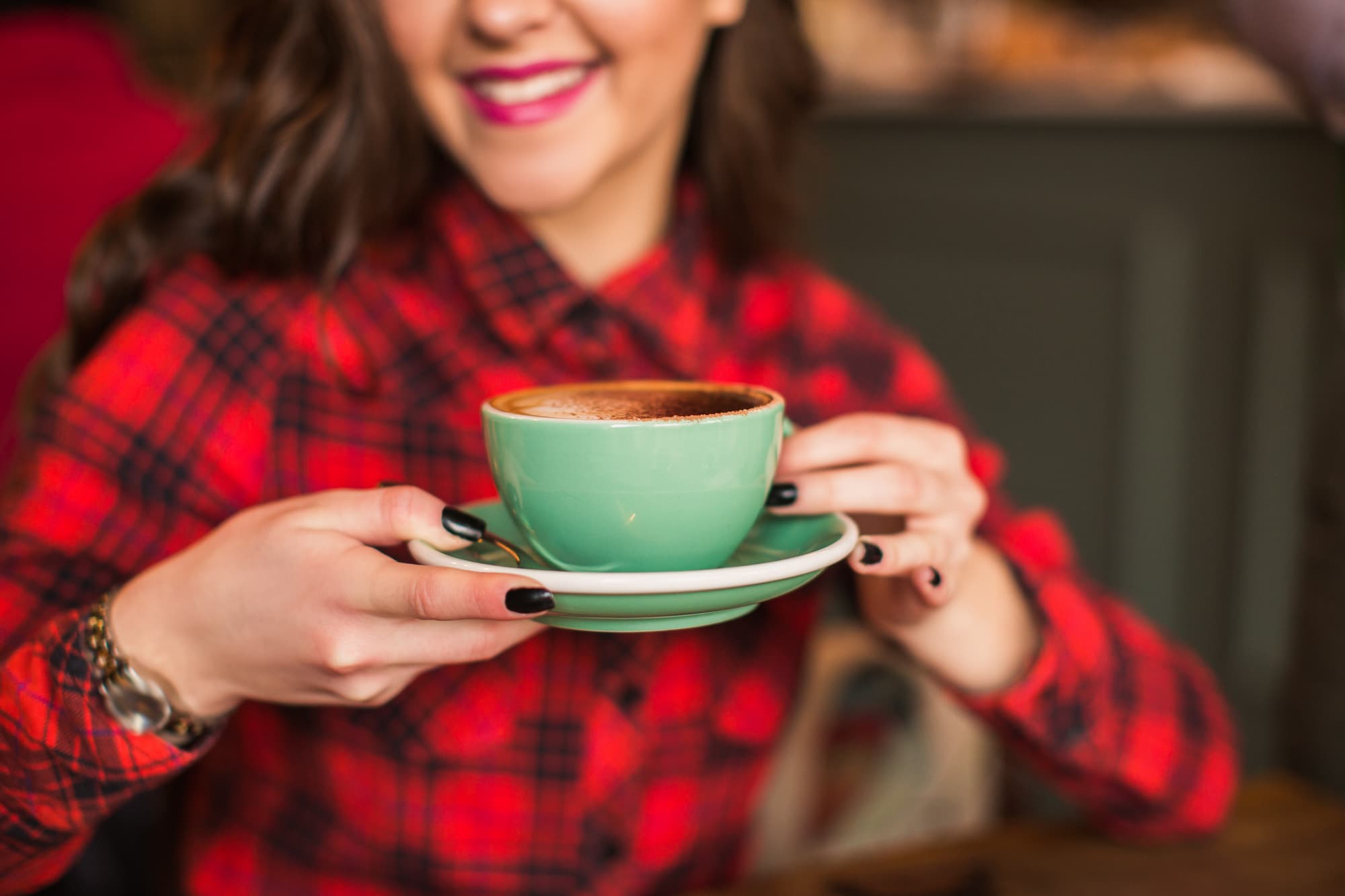 Lady Drinking a coffee with a lovely smile